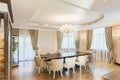 Luxury dining room with wooden table in center.