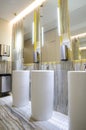 Luxury row with white basins, mirrors and lights. Royalty Free Stock Photo