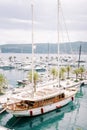 Luxury sailing yacht moored at the pier against the background of motor yachts Royalty Free Stock Photo