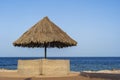 Luxury sand beach with beach chairs and straw umbrellas in tropical resort in Red Sea coast in Egypt, Africa Royalty Free Stock Photo