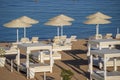 Luxury sand beach with beach chairs and white straw umbrellas in tropical resort in Red Sea coast in Egypt, Africa Royalty Free Stock Photo