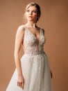 Luxury shiny lace wedding dress. Summer sleeveless bridal gown with tulle skirt and front slit.