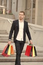 Luxury shopping. Boutique gallery client. Man shopper carries shopping bags urban background. Successful businessman