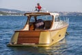 Luxury speed boat made of wood and golden fiber moored to port in the waters