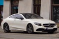 Luxury sport car Mercedes-benz C-class C63 AMG coupe W205 white color, parking on city street. Krakow, Poland 19.02.2020 Royalty Free Stock Photo