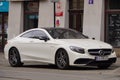 Luxury sport car Mercedes-benz C-class C63 AMG coupe W205 white color, parking on city street. Krakow, Poland 19.02.2020 Royalty Free Stock Photo