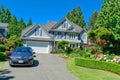 Luxury suburban house with double garage and car parked on concrete driveway Royalty Free Stock Photo