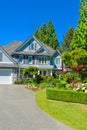 Luxury suburban house with double garage and car parked on concrete driveway Royalty Free Stock Photo