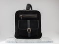 Luxury suet backbag. Luxury black leather and suet backpack on white background, on marble floor.