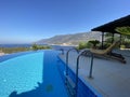 Luxury summer villa with infinity pool and great view of panoramic sea. Royalty Free Stock Photo