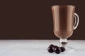 Luxury sweet chocolate dessert in irish coffee glass with round chocolates on dark brown background, copy space.