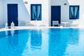 Luxury swimming pool with blue water in a hotel. Santorini island, Greece