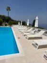 The luxury swimming pool with white sun loungers sunshades Royalty Free Stock Photo