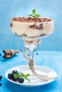Luxury tiramisu dessert in a cocktail glass decorated with cocoa