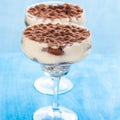 Luxury tiramisu dessert in a cocktail glass decorated with cocoa