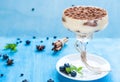 Luxury tiramisu dessert in a cocktail glass decorated with cocoa
