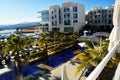 Luxury tourist resort with swimming pool and palm-trees near the sea Royalty Free Stock Photo