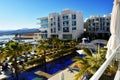 Luxury tourist resort with swimming pool and palm-trees near the sea Royalty Free Stock Photo