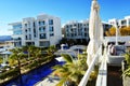 Luxury tourist resort with swimming pool and palm-trees near the sea Royalty Free Stock Photo