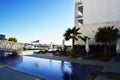 Luxury tourist resort with swimming pool and palm-trees near the sea Royalty Free Stock Photo