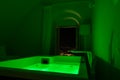 Luxury travel Santorini vacation hotel jacuzzi in colored lights with night view of the city. Royalty Free Stock Photo