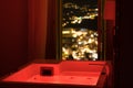 Luxury travel Santorini vacation hotel jacuzzi in colored lights with night view of the city. Royalty Free Stock Photo