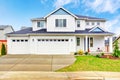 Luxury two level house exterior with garage and concrete driveway. Royalty Free Stock Photo