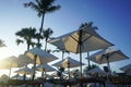 Luxury umbrellas and chairs around outdoor swimming pool with beach view. Luxurious vacation and holiday concept Royalty Free Stock Photo