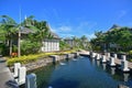 Luxury upscale resort hotel with water flowing into pond surrounded by bungalows Royalty Free Stock Photo