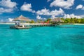 Luxury vacation. Tropical beach with water bungalows on the Maldives with seaplane and amazing blue sea Royalty Free Stock Photo