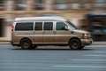 Luxury van Chevrolet Express in the city street in motion. Chevrolet Express GMT610 driving on urban highway