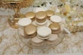 Luxury vanilla and caramel macaroons on gold background.