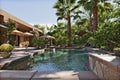 Luxury Villa with waterfall feature and palm trees Royalty Free Stock Photo