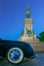 Luxury vintage classic sport car bumper and Monument to Garibaldi in night Rome