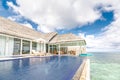 Luxury water villa with infinity pool and terrace overlooking sea bay in Maldives islands