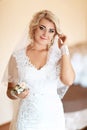 Luxury wedding bride, girl posing and smiling with bouquet, fixes her hair, selective focus