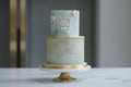 Luxury wedding cake on table, green and gold frosting Royalty Free Stock Photo