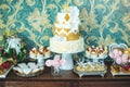 Luxury wedding candy bar with a beautiful white cake decorated with gold ornaments. Concept of chic wedding desserts Royalty Free Stock Photo