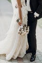 Luxury wedding couple hugging and holding golden bouquet of rose Royalty Free Stock Photo