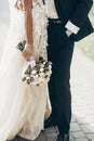 Luxury wedding couple hugging and holding golden bouquet of rose Royalty Free Stock Photo