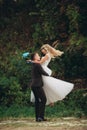 Luxury wedding couple hugging and kissing on the background gorgeous plants and cave near ancient castle Royalty Free Stock Photo