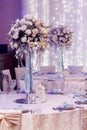 Luxury wedding decor with flowers and glass vases and number of Royalty Free Stock Photo