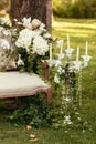 luxury wedding decorations with bench, candle and flowers compisition on ceremony place Royalty Free Stock Photo