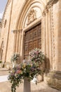 Luxury wedding floral decorations at the entrance of Ostuni church. Royalty Free Stock Photo