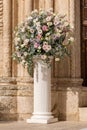 Luxury wedding floral decorations at the entrance of Ostuni church. Royalty Free Stock Photo