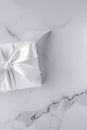 Luxury wedding gifts with silk bow and ribbons on marble background Royalty Free Stock Photo