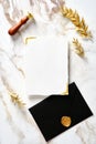 Luxury wedding invitation card mockup with black envelope and wax seal stamp on gold marble table..Wedding stationery set top view Royalty Free Stock Photo