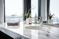 Luxury white bathroom interior design, round undermount wash basin on shinny white marble counter and window with city view, Royalty Free Stock Photo