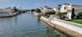 Luxury white buildings on city canal. Expensive villas and small boats on urban chanel