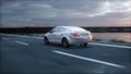 Luxury white car on highway, road. Very fast driving. Wonderfull sunset. Travel and motivation concept. 3d rendering. Royalty Free Stock Photo